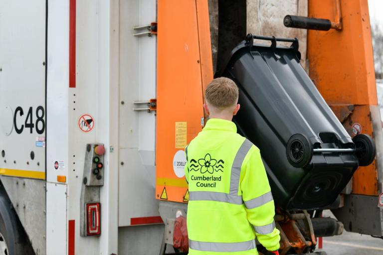 Man emptying waste bin