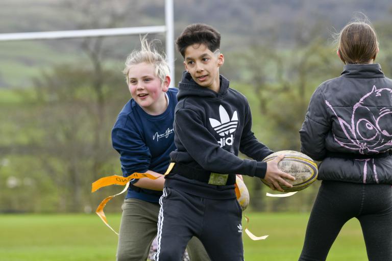 Children playing tag rugby